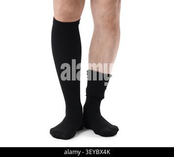 Man wearing mismatched black socks on white background Stock Photo