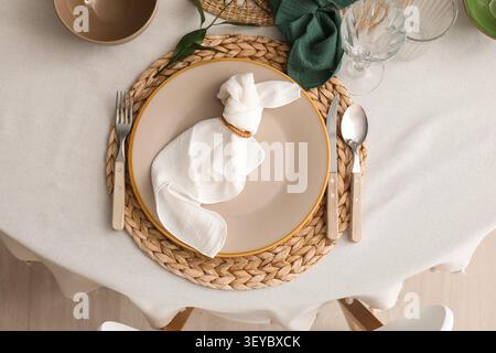 Elegant table setting with napkin folded like a bunny Stock Photo