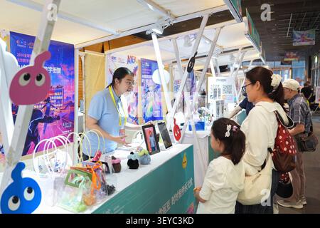 (260703) -- BEIJING, July 3, 2026 (Xinhua) -- A staff member introduces several interactive digital products to visitors at a digital economy experience fair in the Longfusi commercial area in Dongcheng District, Beijing, capital of China, July 2, 2026. The 2026 Global Digital Economy Conference kicked off in Beijing on Thursday. On the sidelines of the event, the digital economy experience fair has been opened to the public at the Longfu Mansion in the Longfusi commercial area since June 27, showcasing new scenarios, new achievements and new business formats in digital economy. The experie Stock Photo