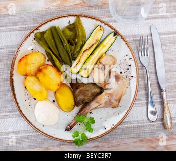 Roasted rabbit served with vegetable garnish Stock Photo