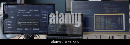 Computer Monitors Displaying Software Code in Information Technology Office Stock Photo