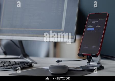 Smartphone Displaying Network Security Dashboard in Information Office Stock Photo