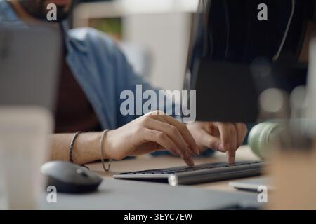 Adult Man Typing on Keyboard in Information Technology Office Stock Photo