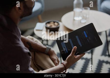 Adult Man Reviewing Data Dashboard on Tablet for Office Work Stock Photo