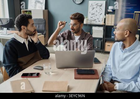 Diverse Businessmen Discussing Strategy in Office Meeting Stock Photo