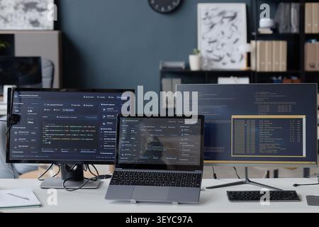 Developer Workstation Displaying Code for Cybersecurity Monitoring Stock Photo