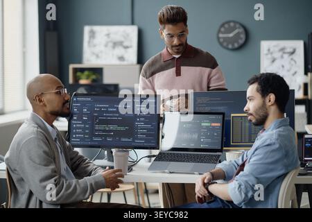 Diverse Men Collaborating on Software Development in it Office Stock Photo