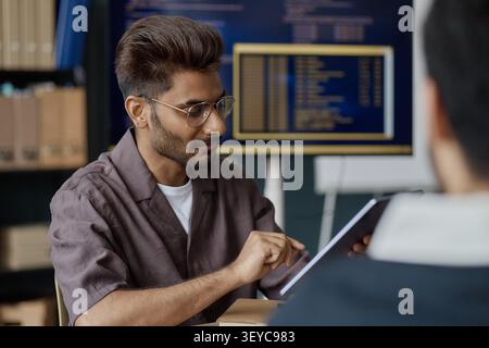 Man Using Tablet during Office Collaboration Meeting Stock Photo