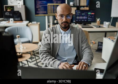 Portrait of Man Working at Computer in Information Technology Office Stock Photo