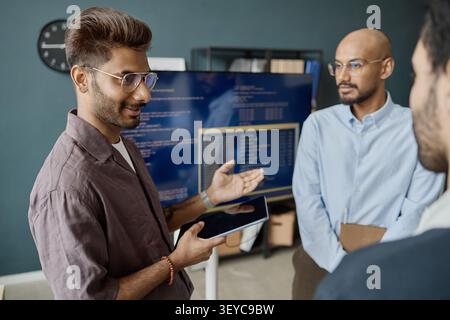 Indian Men Discussing Software Project in Information Technology Office Stock Photo