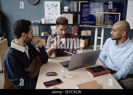 Diverse Adult Men Discussing Software Project in IT Office Stock Photo