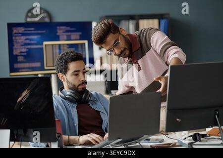 Two Men Collaborating on Software Development in IT Office Stock Photo