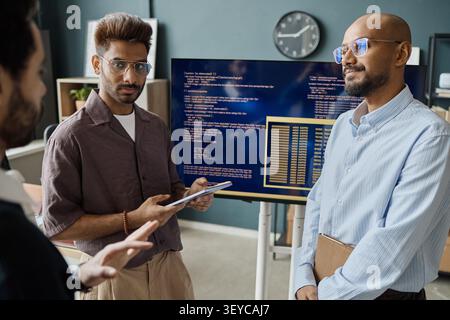 Indian Men Discussing Software Development in Information Office Stock Photo