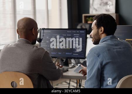 Men Reviewing Software Code in Information Technology Office Stock Photo