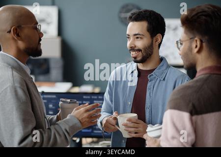 Multiethnic Men Discussing Project during Break in it Office Stock Photo