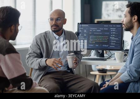 Man Leading Software Team Discussion in Information Technology Office Stock Photo