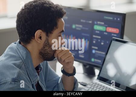 Man Analyzing Data Dashboard in Information Technology Office Stock Photo