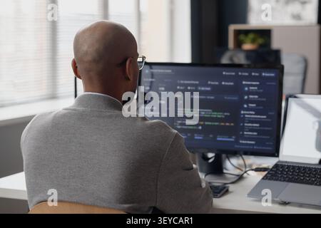 Man Coding at Desktop Computer in Information Technology Office Stock Photo