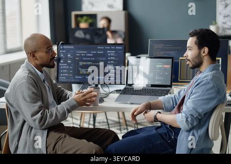 Men Discussing Software Development Strategy in it Office Stock Photo