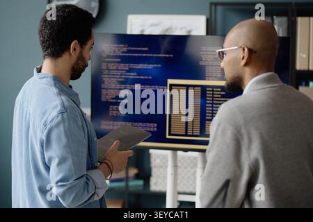 Men Monitoring Programming Output on Screen in it Office Stock Photo