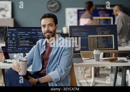 Portrait of Man Sitting in IT Office for Software Development Stock Photo