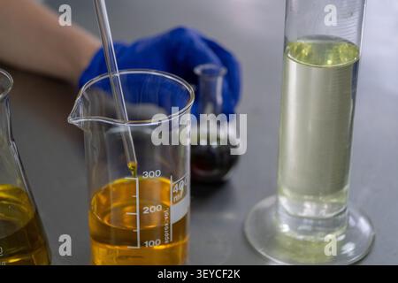 Laboratory Technician Handling Liquid Samples During Quality Control Testing Stock Photo