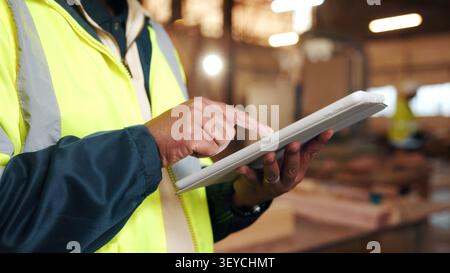 Carpenter, scroll and hands with tablet in workshop, manufacturing or tracking project update on web. Woodworking, design research and person with Stock Photo