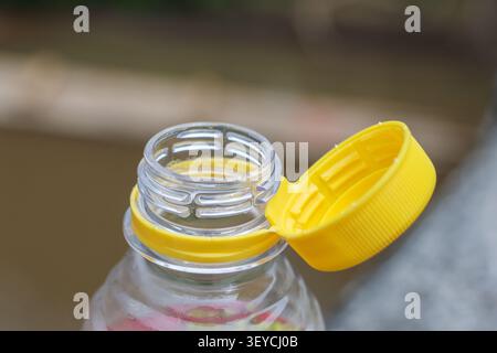 A yellow cap plastic bottle open bottle transparent bottle bottle neck bottle lid drinking bottle container close up plastic container beverage contai Stock Photo