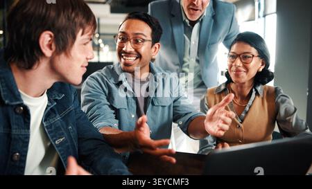 Laptop, discussion and business people in office with feedback on software development project. Happy, review and team of web designers with manager Stock Photo