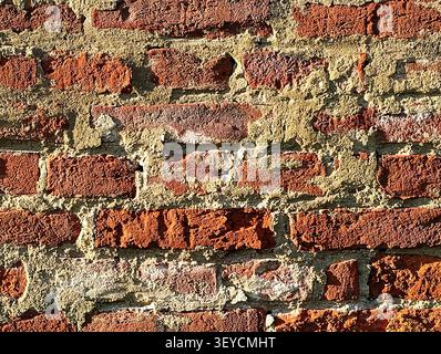 Old cracky bricks texture background in grazing light. Stock Photo