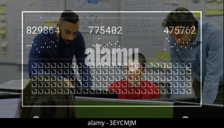 Team analyzing business KPIs as semi-transparent overlay appearing and updating grid on monitor Stock Photo