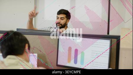 Vertical image: Bearded man waving then typing, overlaying lines on business chart, both laughing Stock Photo