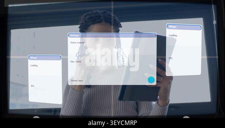 Vertical image: Woman tapping tablet, sipping mug by bright window, starting tech sync updating UI Stock Photo