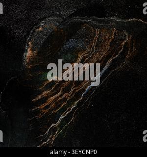 Abstract cosmic fluid art texture with golden glitter veins and metallic waves on black background Stock Photo