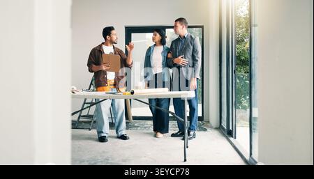 Designer, couple and discussion with homeowner in agreement, deal and planning at construction site. People, client collaboration and conversation for Stock Photo