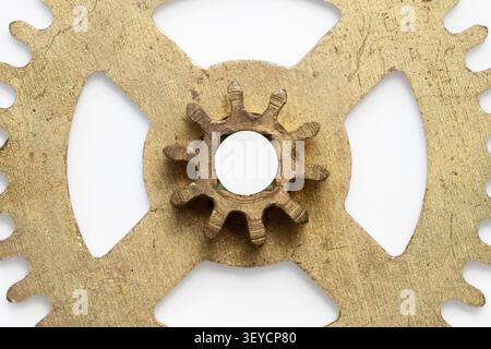 Vintage brass gear horizontal macro closeup of clockwork mechanism isolated on clean white background Stock Photo