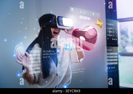 Asian woman wearing VR headset designing 3D heart model in virtual reality Stock Photo