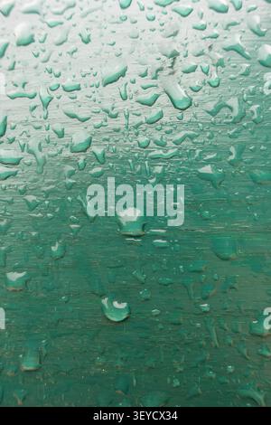 macro view of droplets of rain on a green surface Stock Photo