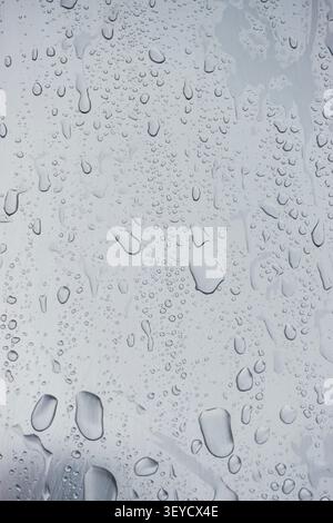 Grey abstract close-up of water droplets on a metal surface Stock Photo
