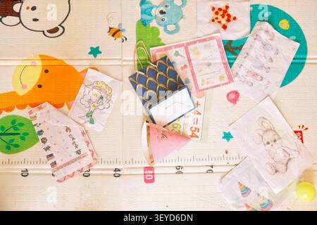 Educational worksheets, colorful stationery, stickers, and learning materials arranged on a children's study table. Perfect for homeschooling Stock Photo