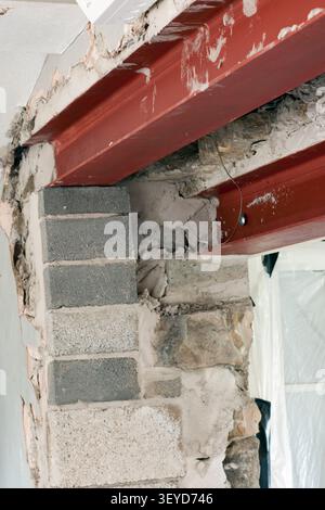 Twin steel RSJ's supporting an interior 2 feet thick stone interior wall which was formerly an exterior wall Stock Photo