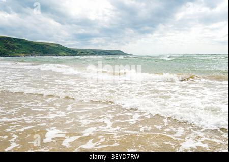 Waves rolling onto a quiet sandy beach Stock Photo