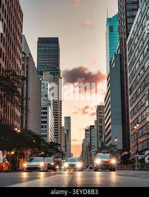 Low angle view of traffic on a Manhattan street at sunset Stock Photo