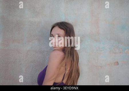 Young woman looking back over her shoulder Stock Photo