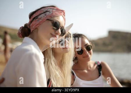 Three girlfriends in sunglasses enjoying the sunshine Stock Photo