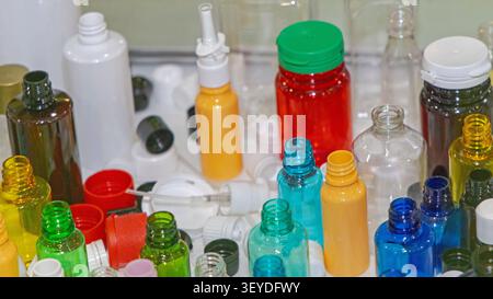 Screw Neck Caps Various Size of New Colourful Plastic Bottles at Shelf Stock Photo
