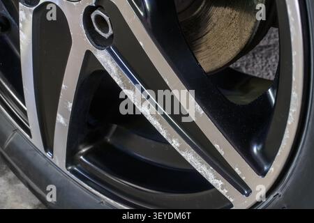 Corrosion of the wheel disc of the car. Corrosion of a modern alloy wheel after winter reagents on the roads. Stock Photo