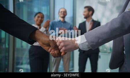 Two diversity business men handshake team shaking hands background of office multiracial workers joyful applause celebrate welcoming hiring new worker Stock Photo