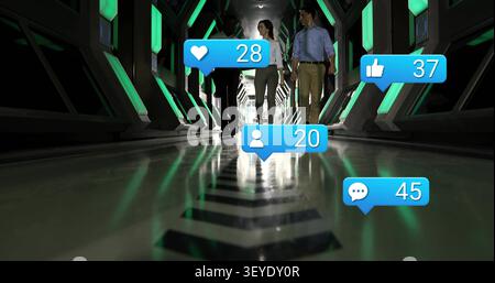 Team of three walking toward camera in tech tunnel, driving animated like or comment bubbles peaking Stock Photo