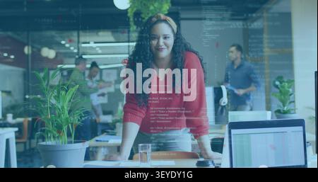 Woman lead leaning on desk, placing hands and causing code overlay across laptop chart for tech Stock Photo